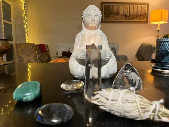 crystals and statue on table